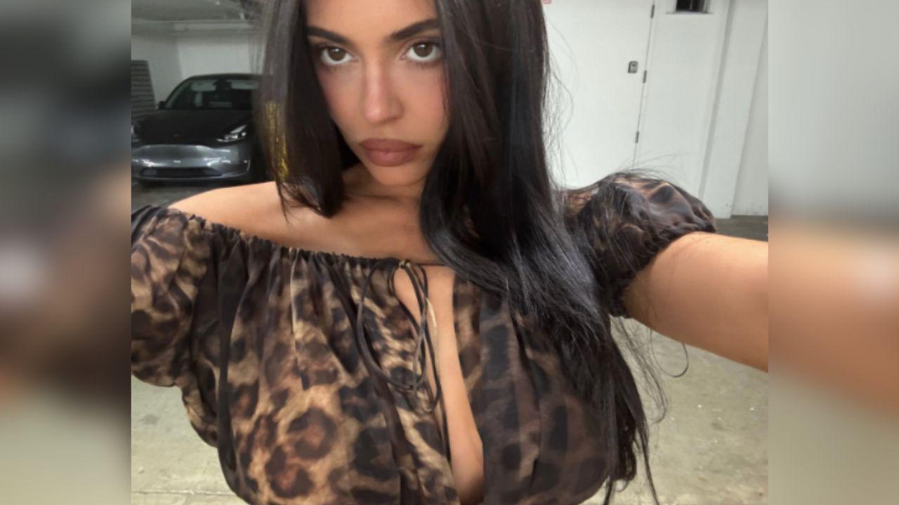 Image of Kylie Jenner took another selfie in a silk top designed by her clothing company, Khy.