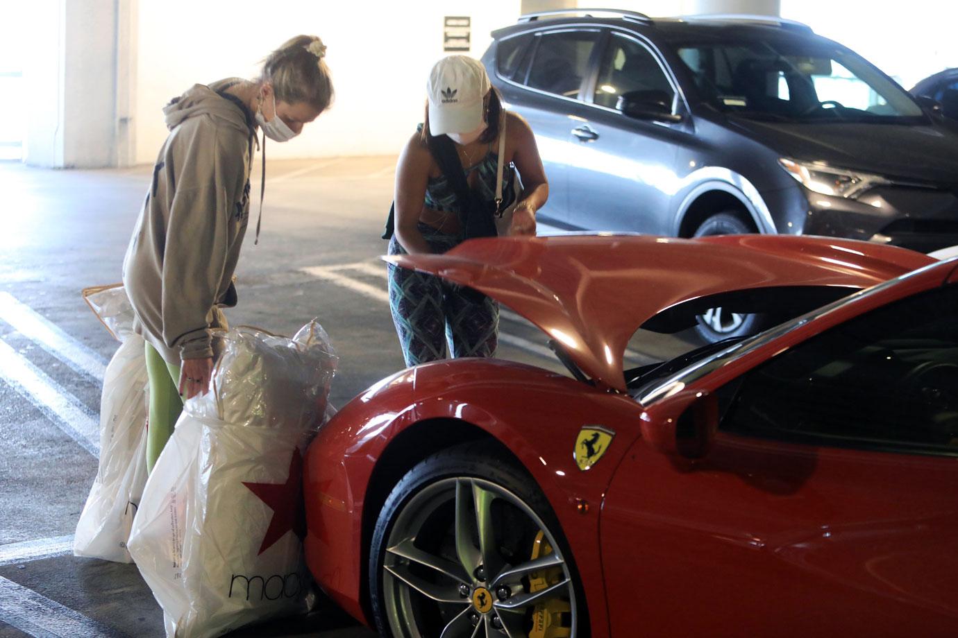 Vanessa Hudgens stuffs her Ferrari after early holiday shopping at the mall.