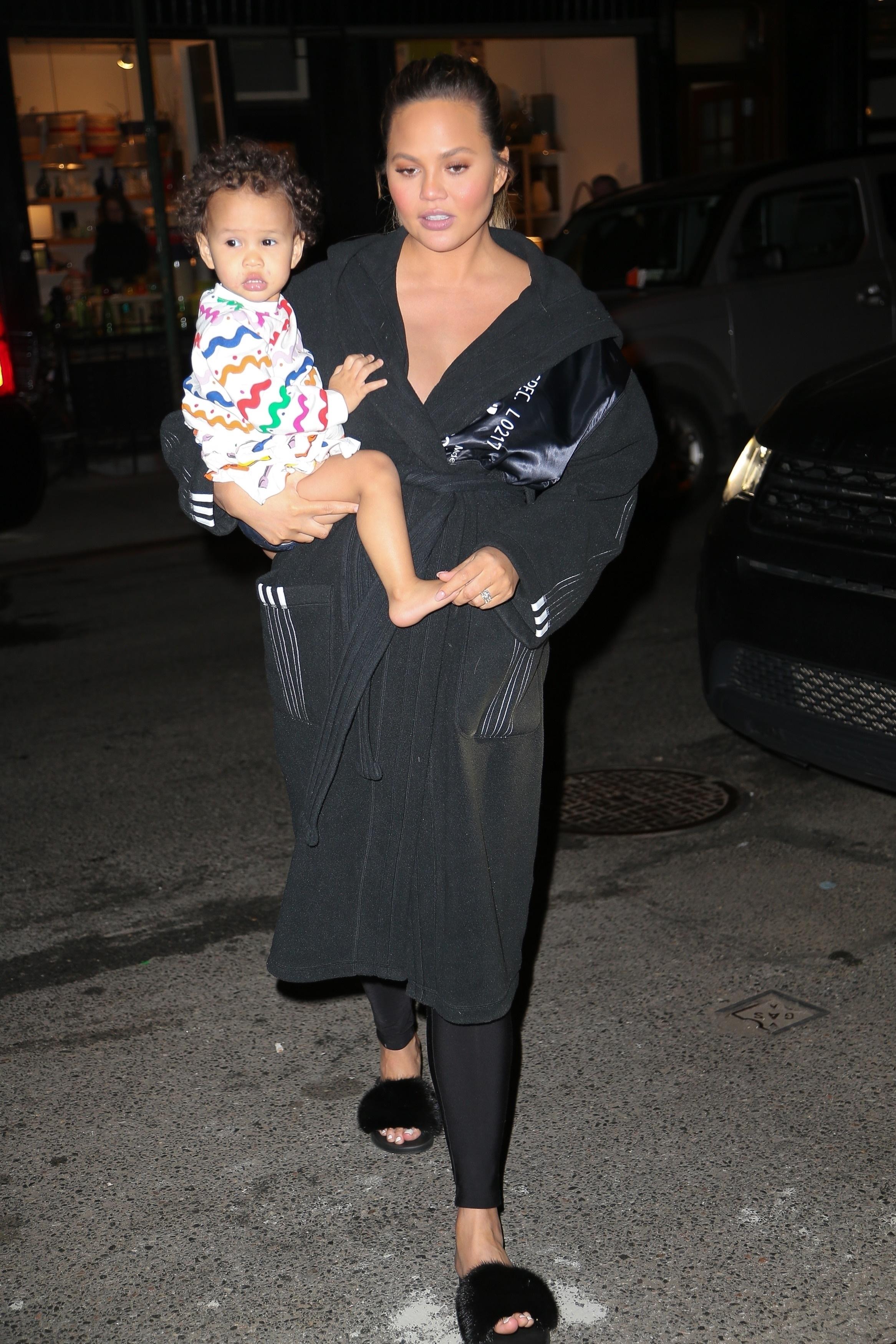 Chrissy Teigen seen with daughter Luna following a early morning eviction from their NYC town home