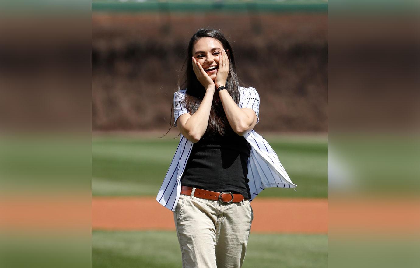 Mila Kunis sports fitted LA Dodgers jersey and skinny jeans to throw the  game's first pitch