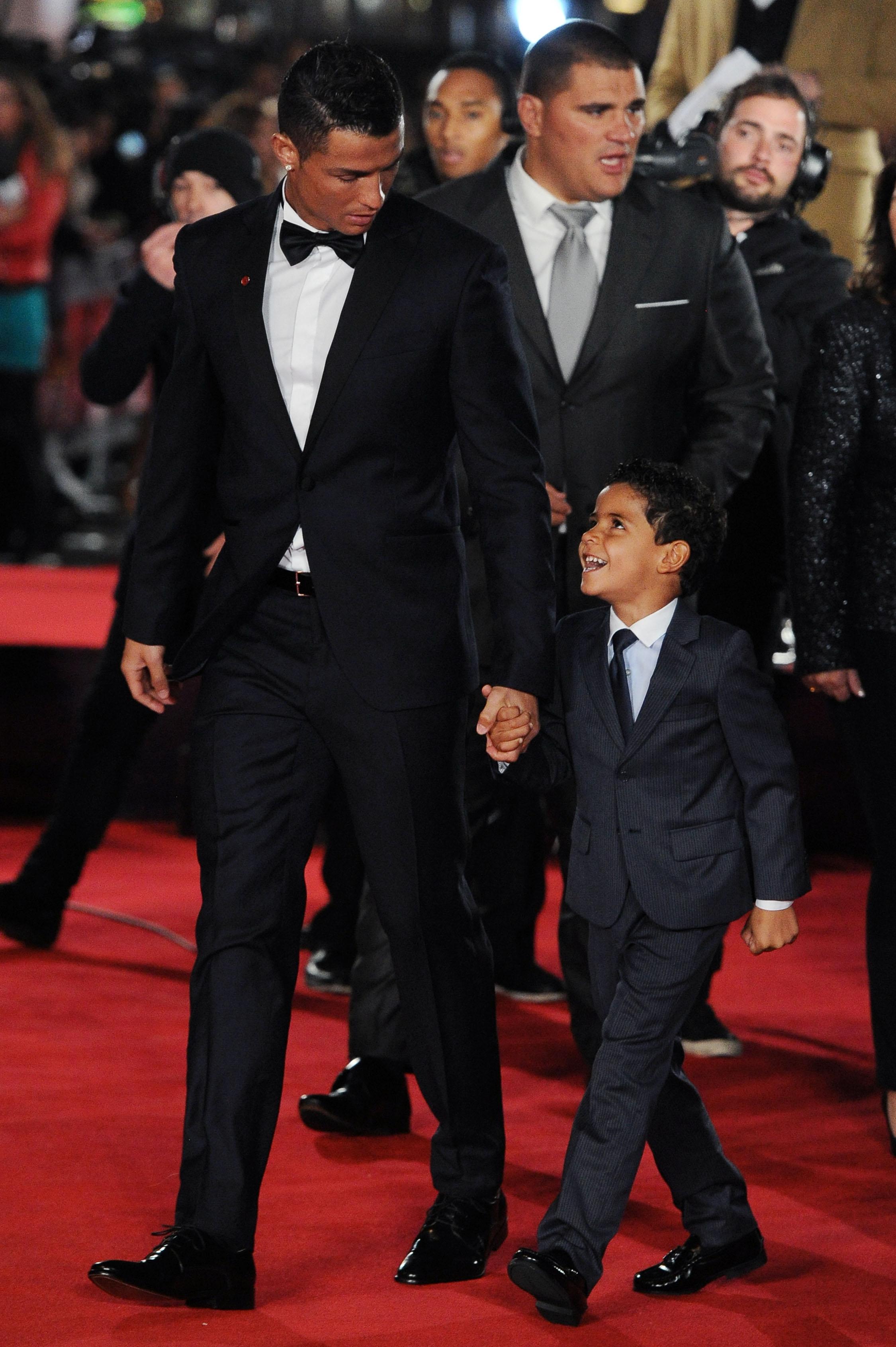 Cristiano Ronaldo kisses his son and poses with Sir Alex Ferguson and several guests at the world premiere of &#8216;Ronaldo&#8217; in London