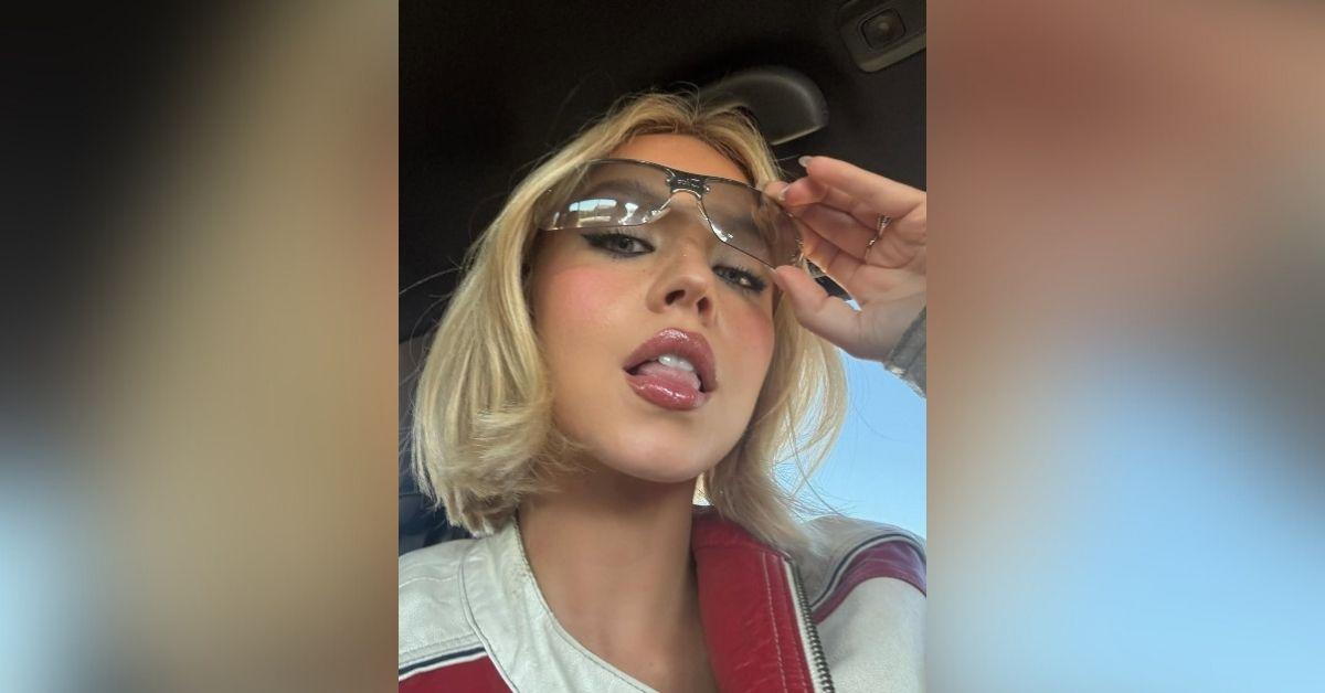 image of Sydney Sweeney stunned in a bold outfit at a NASCAR race.