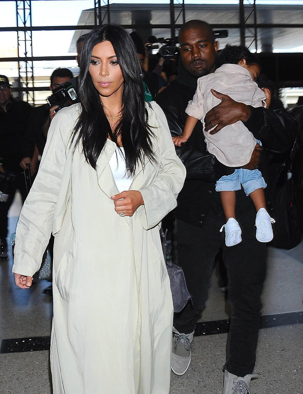 Kim Kardashian &amp; Kanye West Catch A Flight With North