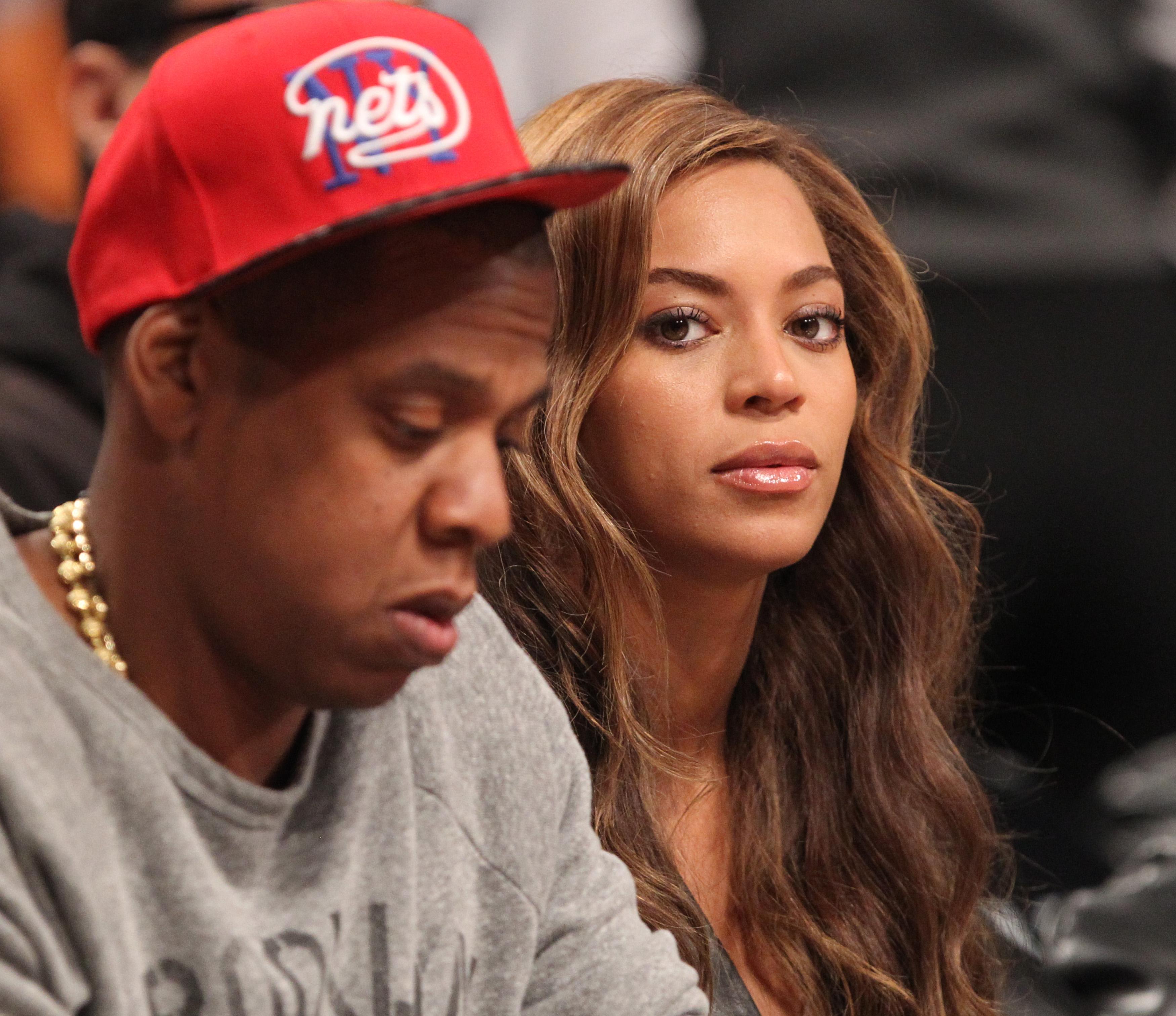 Jay Z and Beyonce sitting in the front row at the Toronto Raptors vs. Brooklyn Nets at the Barclays Center