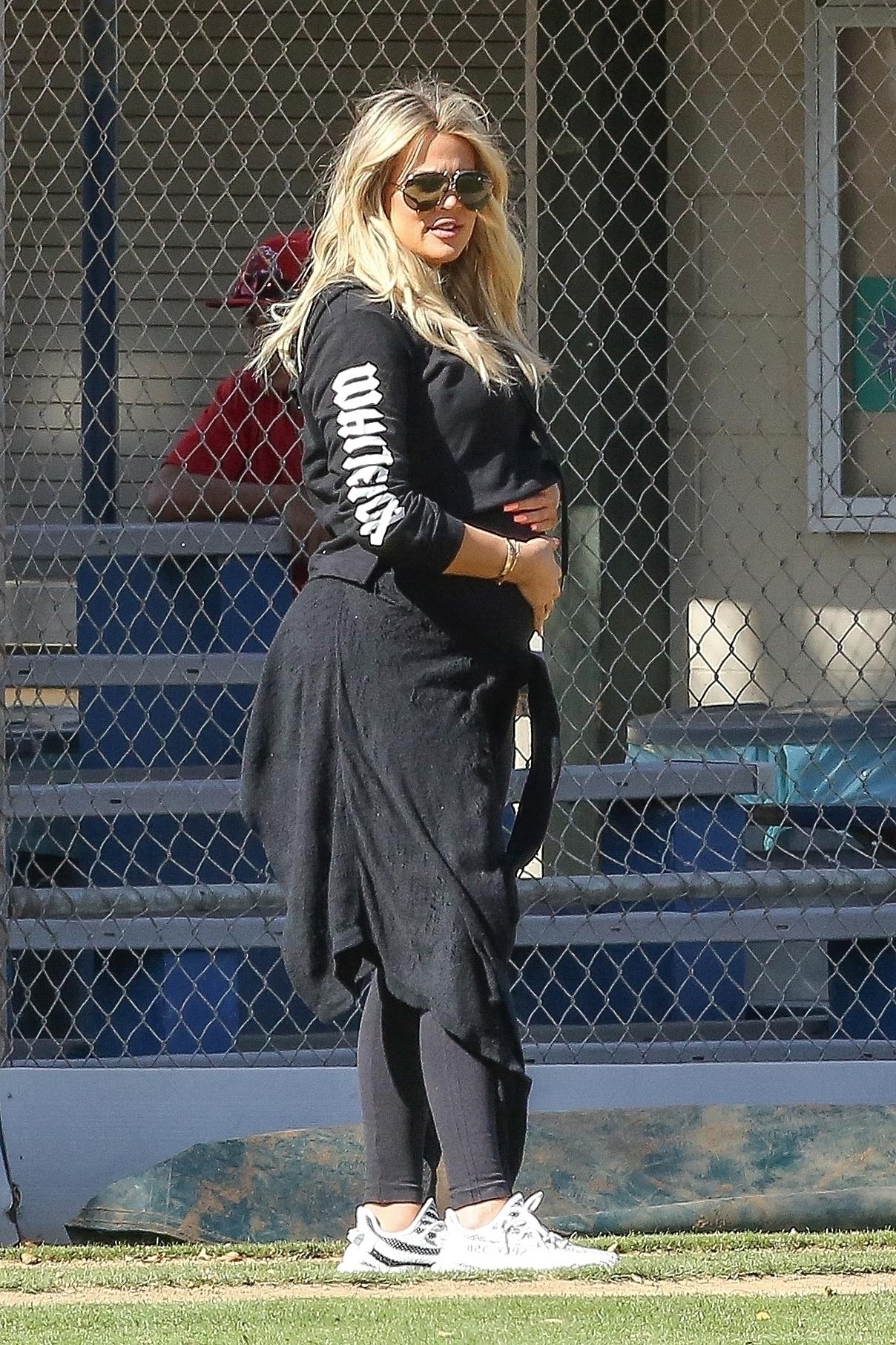 *EXCLUSIVE* Khloe Kardashian caresses her baby bump on the Baseball Diamond