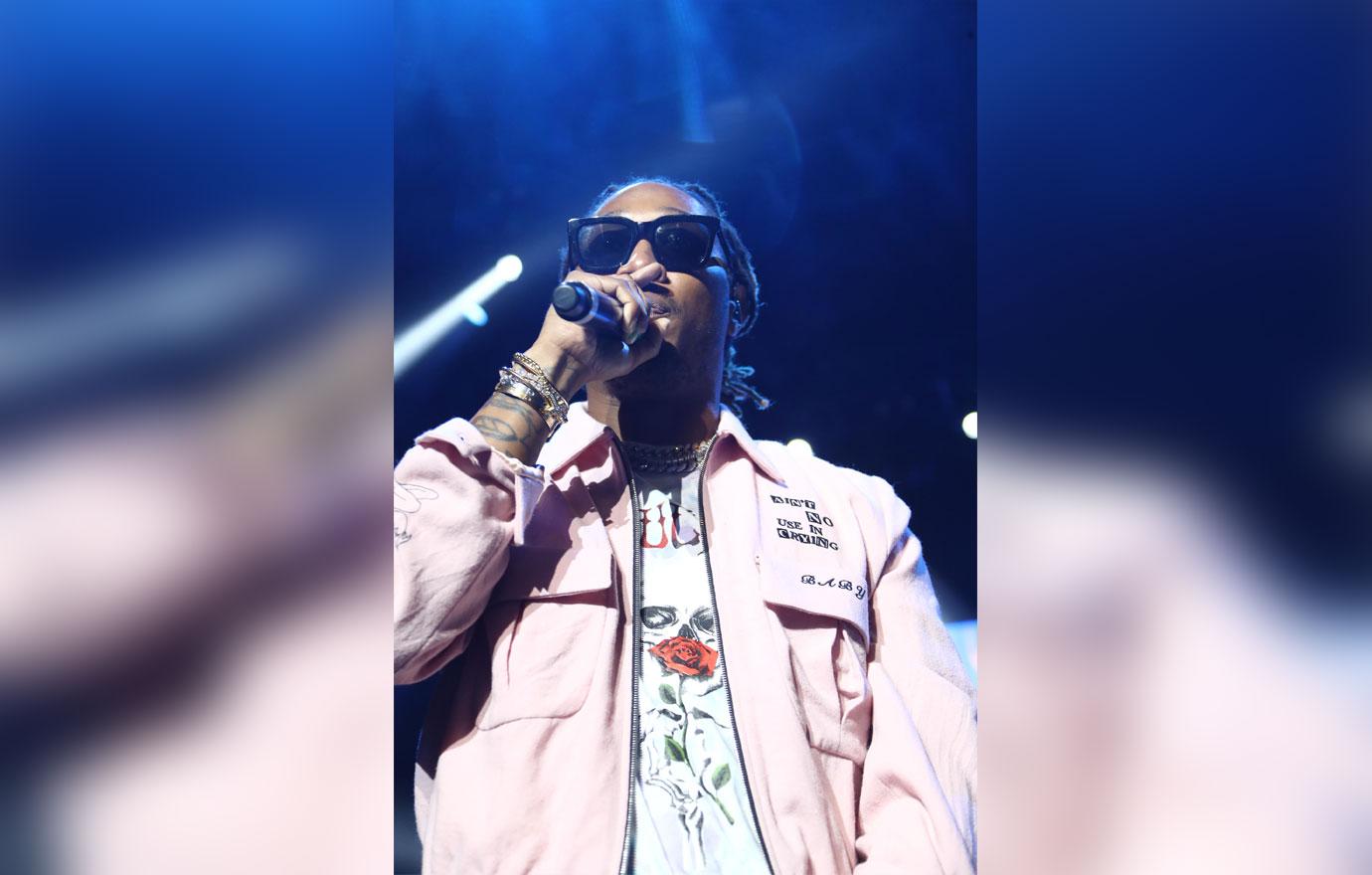 Rapper Future in pink jacket and performing on stage