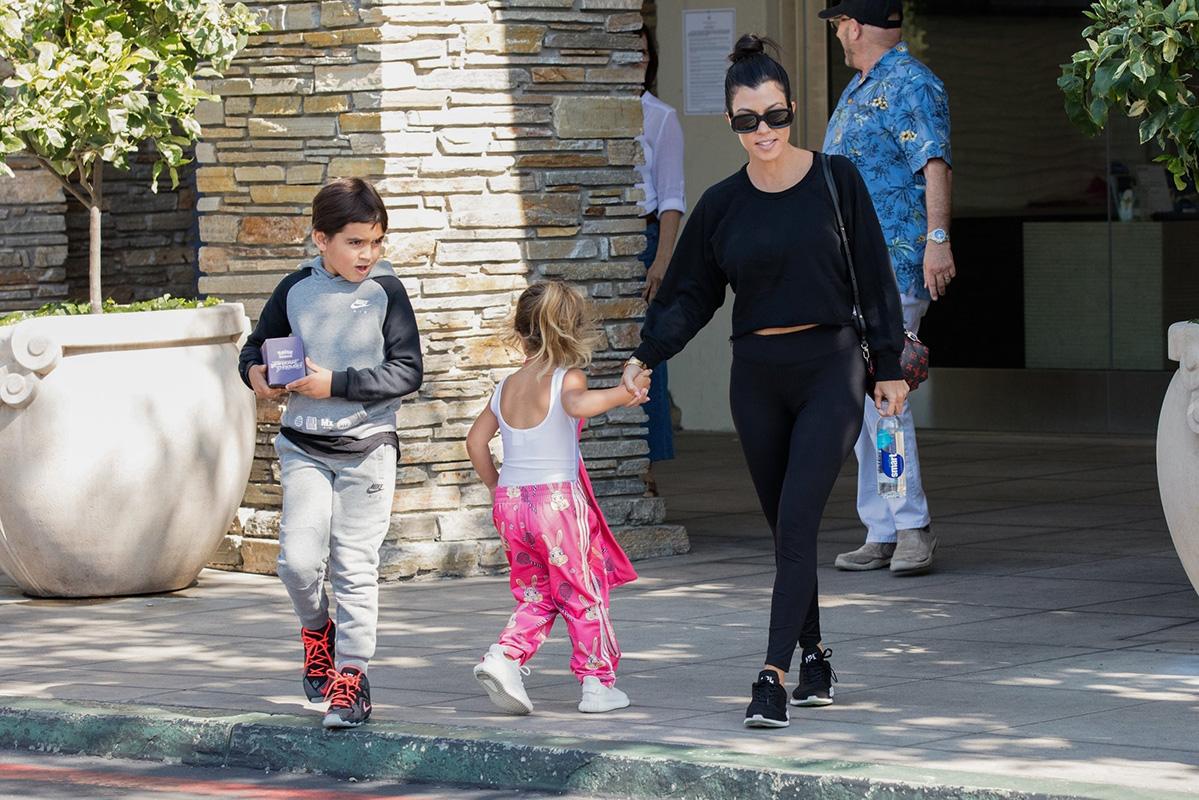 Kourtney Kardashian takes her kids to the movies while Scott Disick lives it up in London