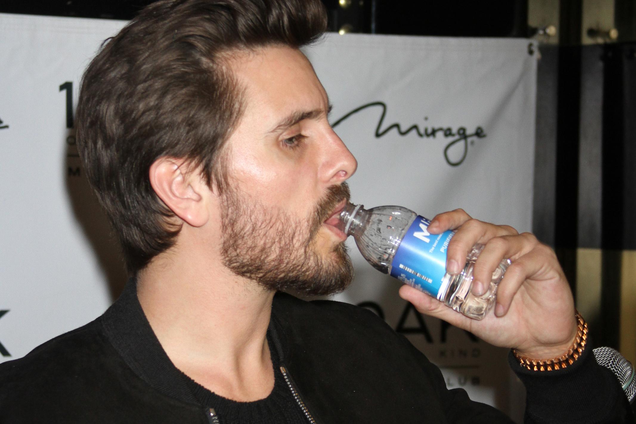 Scott Disick sips water while hosting a party at 1OAK nightclub in Las Vegas