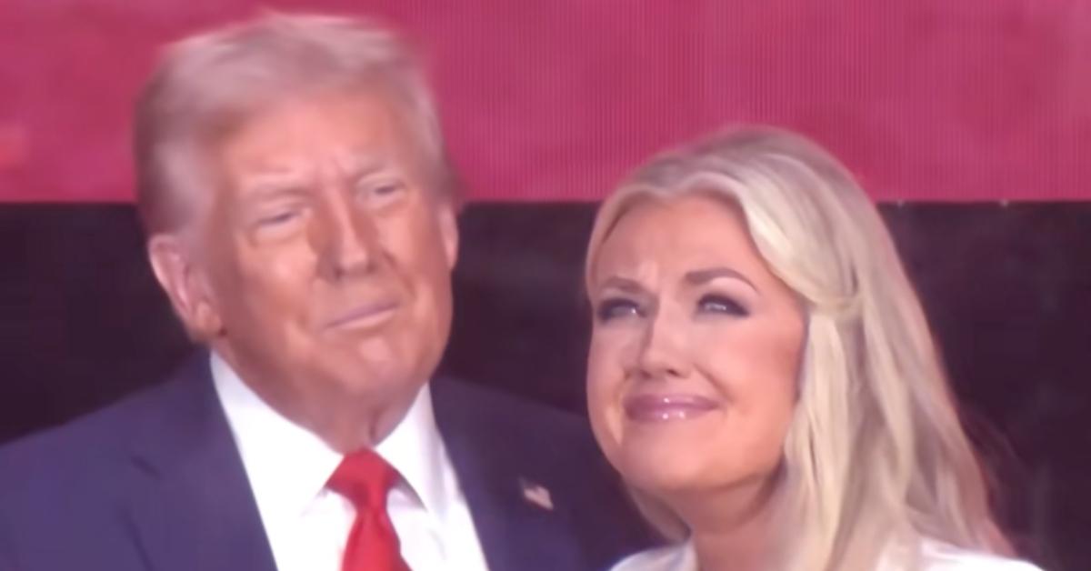 Image of Donald Trump and Erika Kirk stood behind bulletproof glass at Charlie Kirk's memorial service.