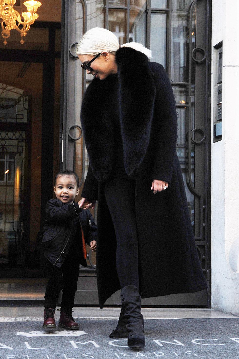 Kim Kardashian and her daughter North West leaving their hotel in Paris