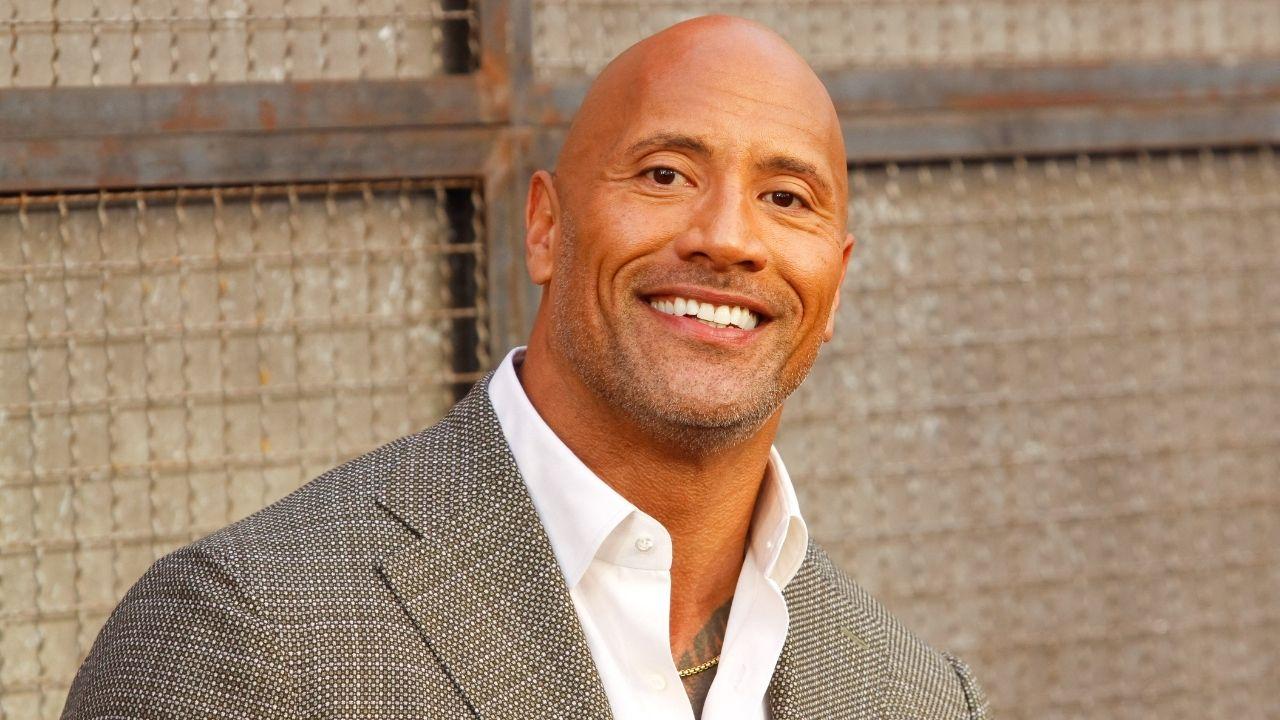 Image of The Rock's costume included a bucket hat, a trench coat, a goofy tie, and dad sneakers to bring his character, The Chicken Man, to life.