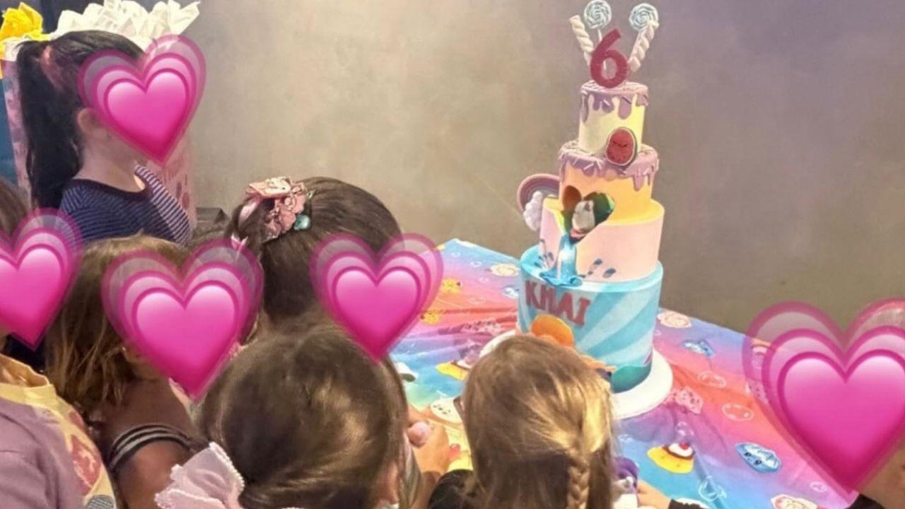 Image of Khai celebrated turning 6 with an elaborate four-tiered cake complete with colorful decorations, a rainbow and a glittery topper.