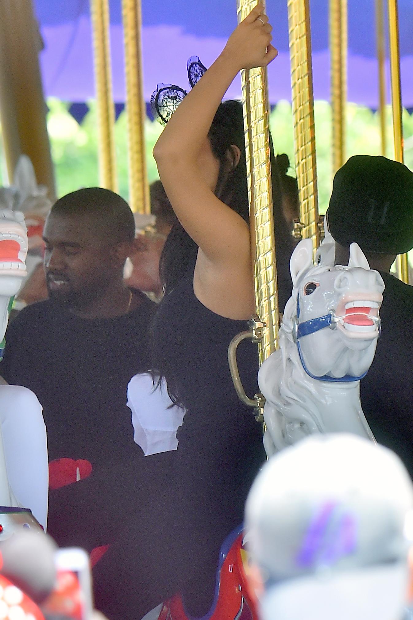 Kim Kardashian and her family enjoy a carousel ride at disneyland on North&#8217;s 2nd birthday