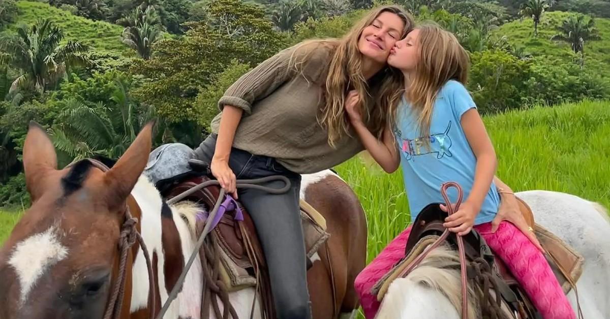 Gisele Bundchen sits on suitcase on beach in bizarre pics after