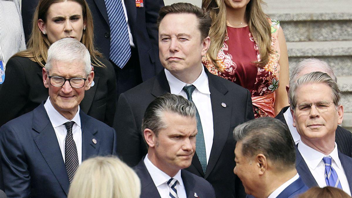 Image of He stayed seated during a selfie moment with executives.