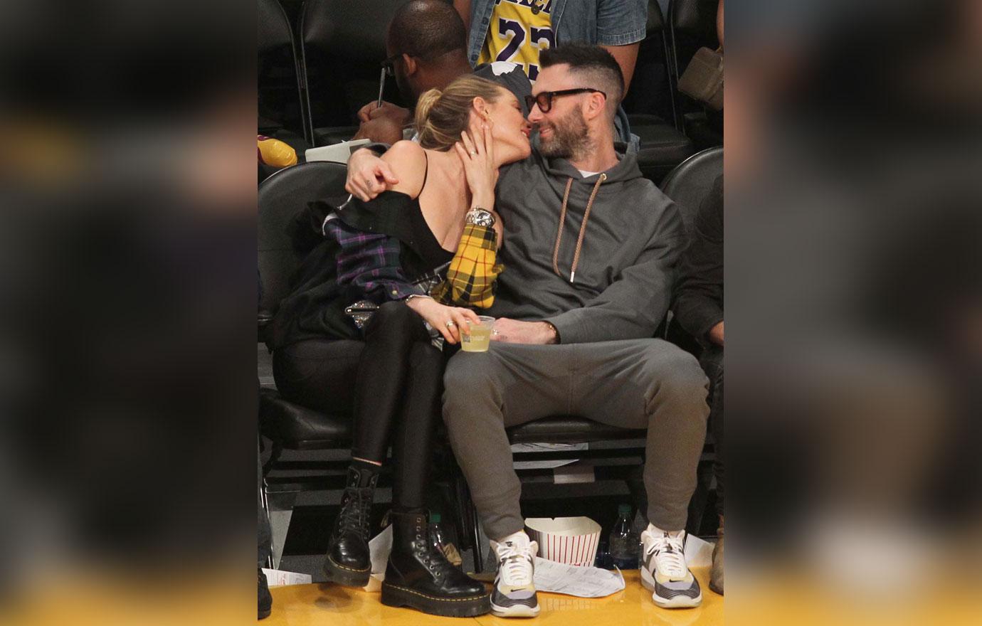 Adam Levine and Behati Prinsloo watch the Los Angeles Lakers play the Houston Rockets