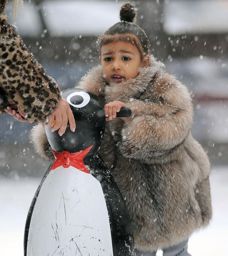 **PREMIUM EXCLUSIVE RATES APPLY** Kim Kardashian helps North West ice skate for the very first time as she plays in the snow with her mom in NYC