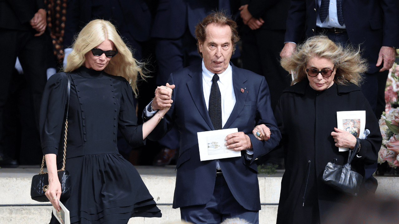 image of Claudia Schiffer wore an understated black dress, tights, pointed-toe heels and a quilted handbag for the emotional occasion.