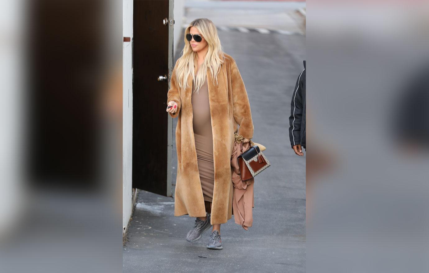 A pregnant Khloe Kardashian changes into Yeezys at the studio to be more comfortable