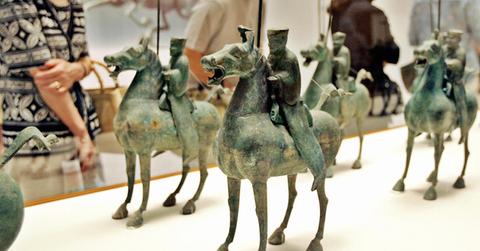 Japanese visitors admire bronze sculptur