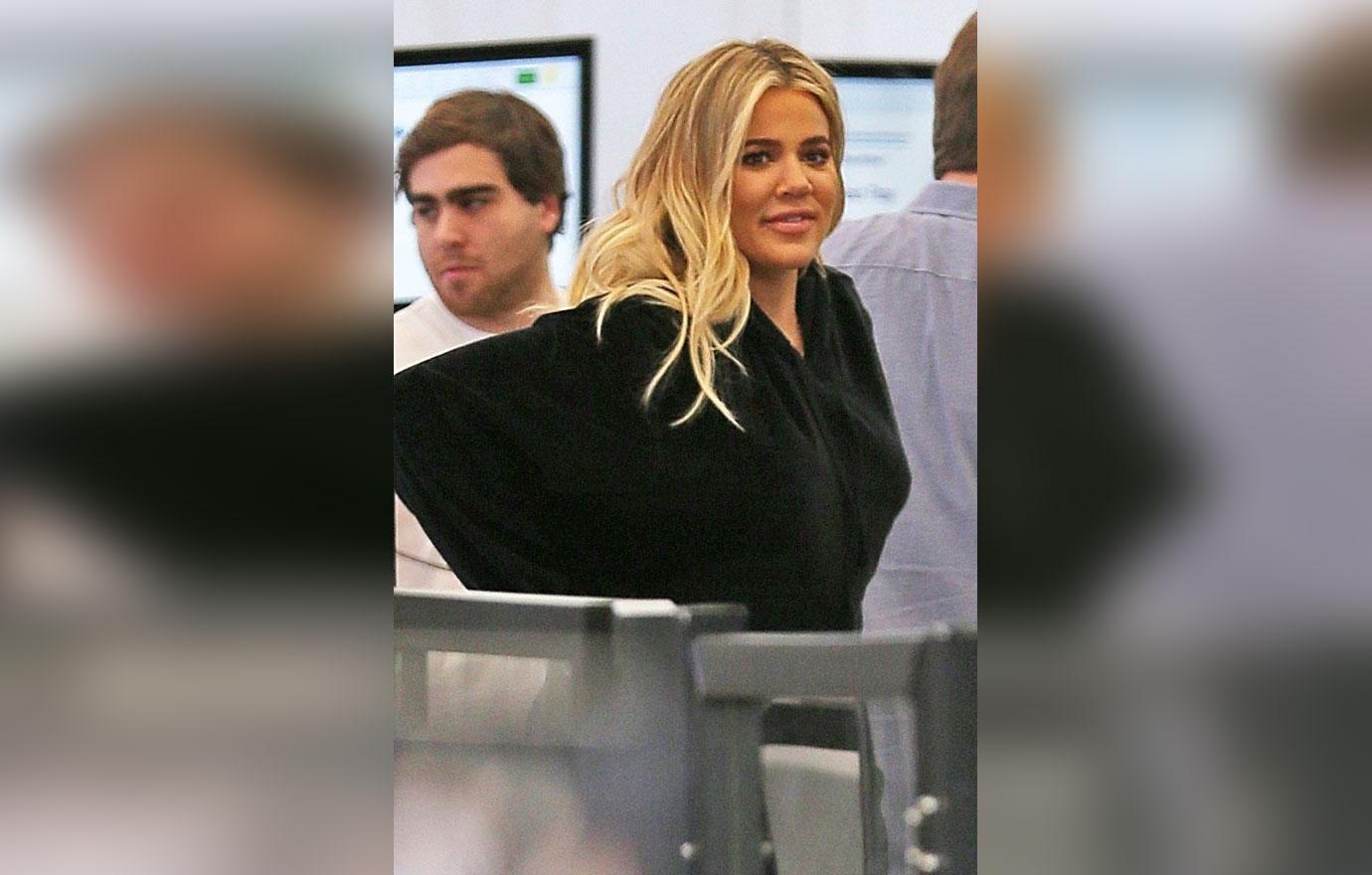 Khloe Kardashian hides her baby bump as she departs LAX