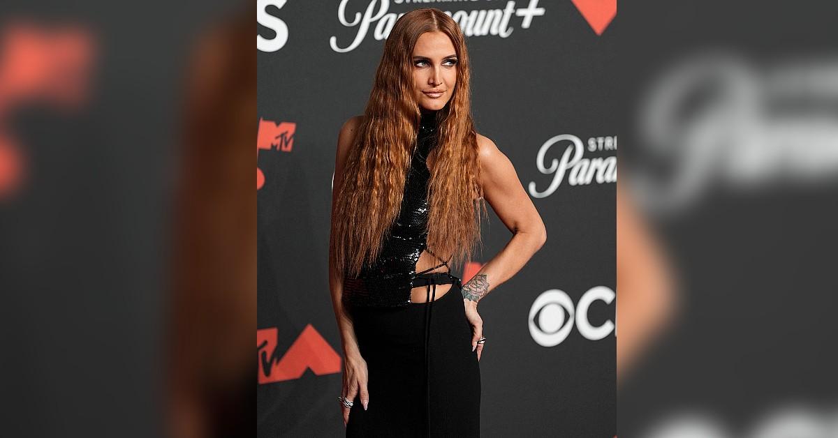 Image of Ashlee Simpson posed in a black cut-out dress.