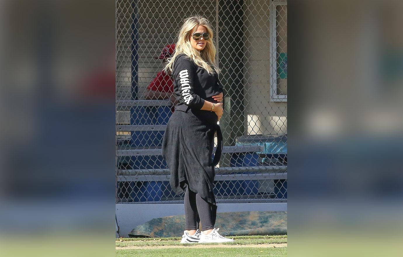 *EXCLUSIVE* Khloe Kardashian caresses her baby bump on the Baseball Diamond