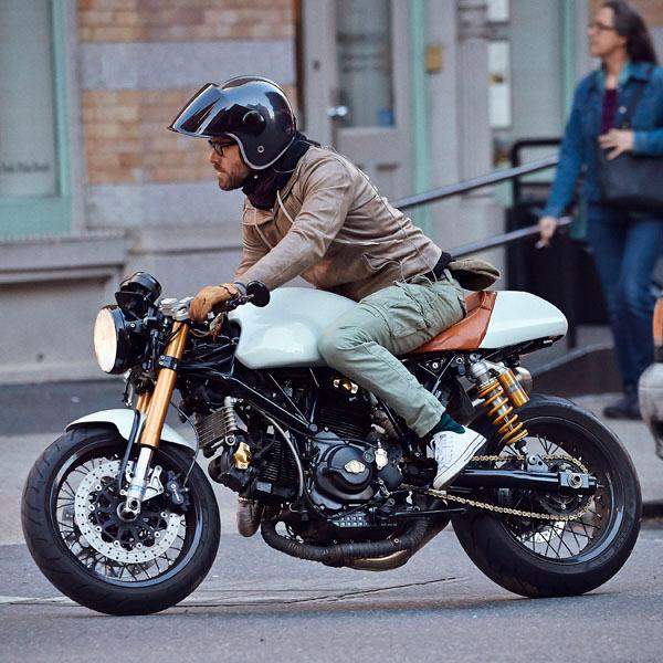 Ryan Reynolds riding on his motorcycle in the SoHo neighborhood of NYC