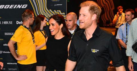 prince harry follows behind meghan markle leaving nigeria tour