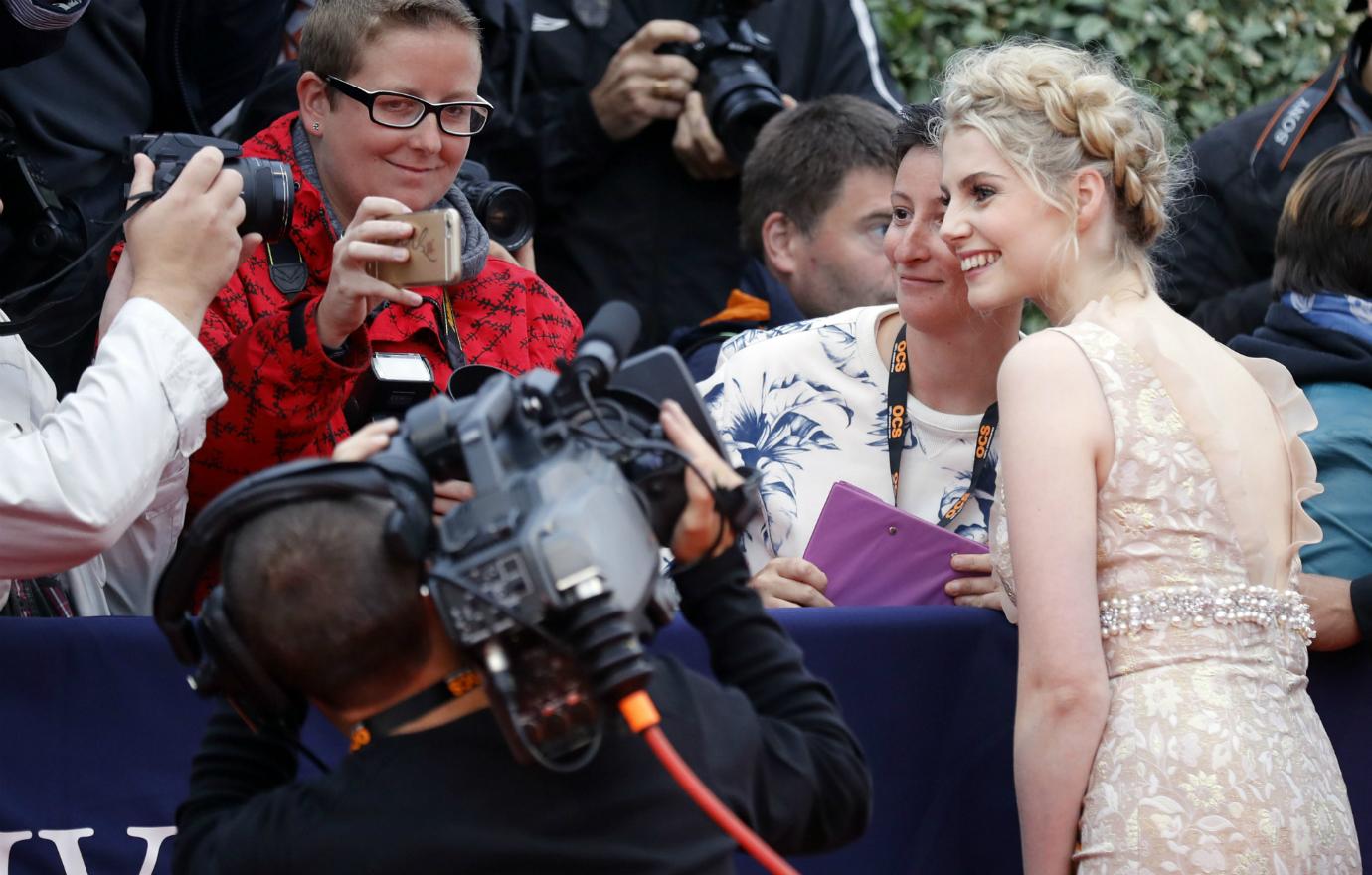 Lucy Boynton poses for fans on the red carpet.