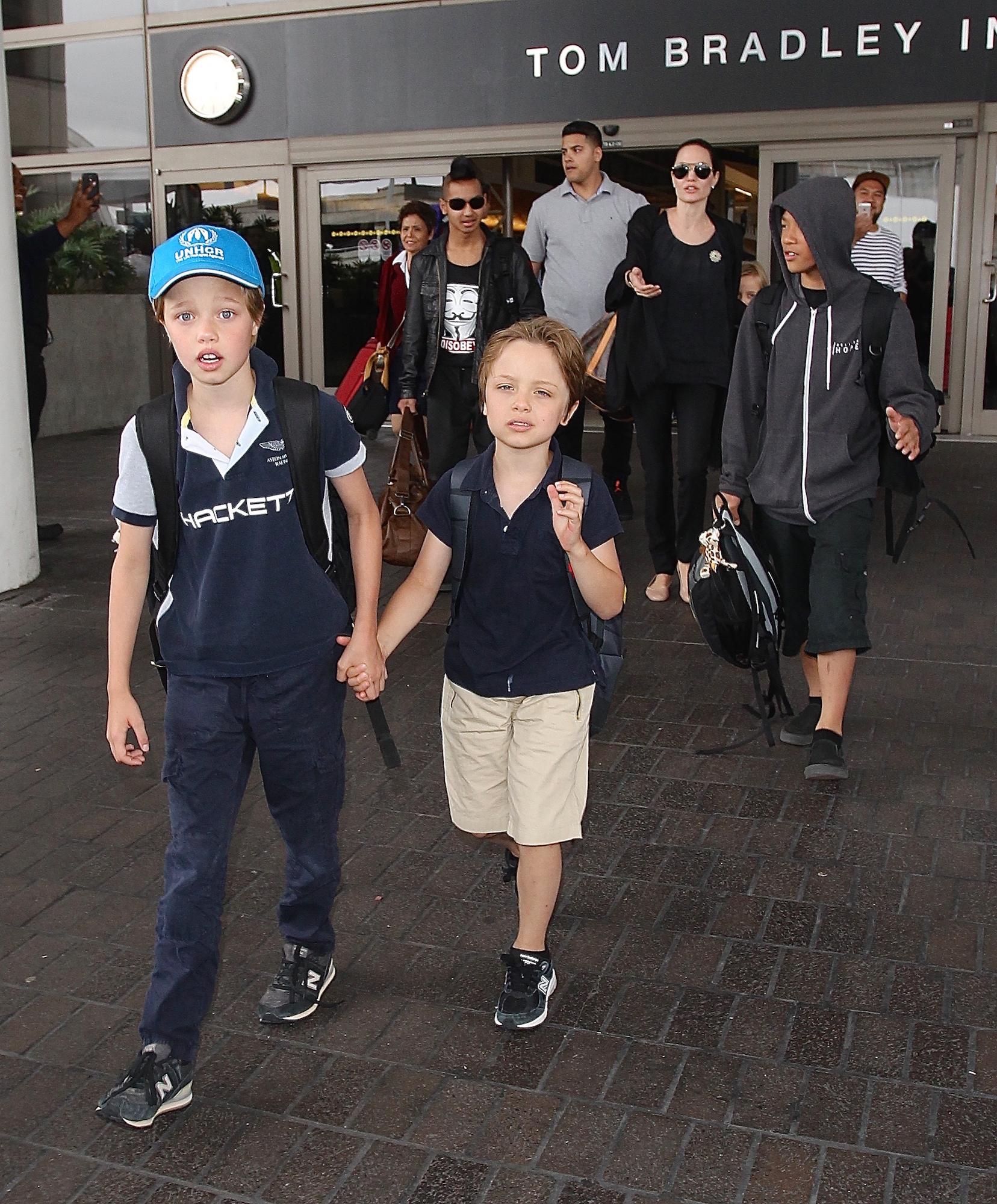 Brad Pitt and Angelina Jolie seen arriving into LAX with their family