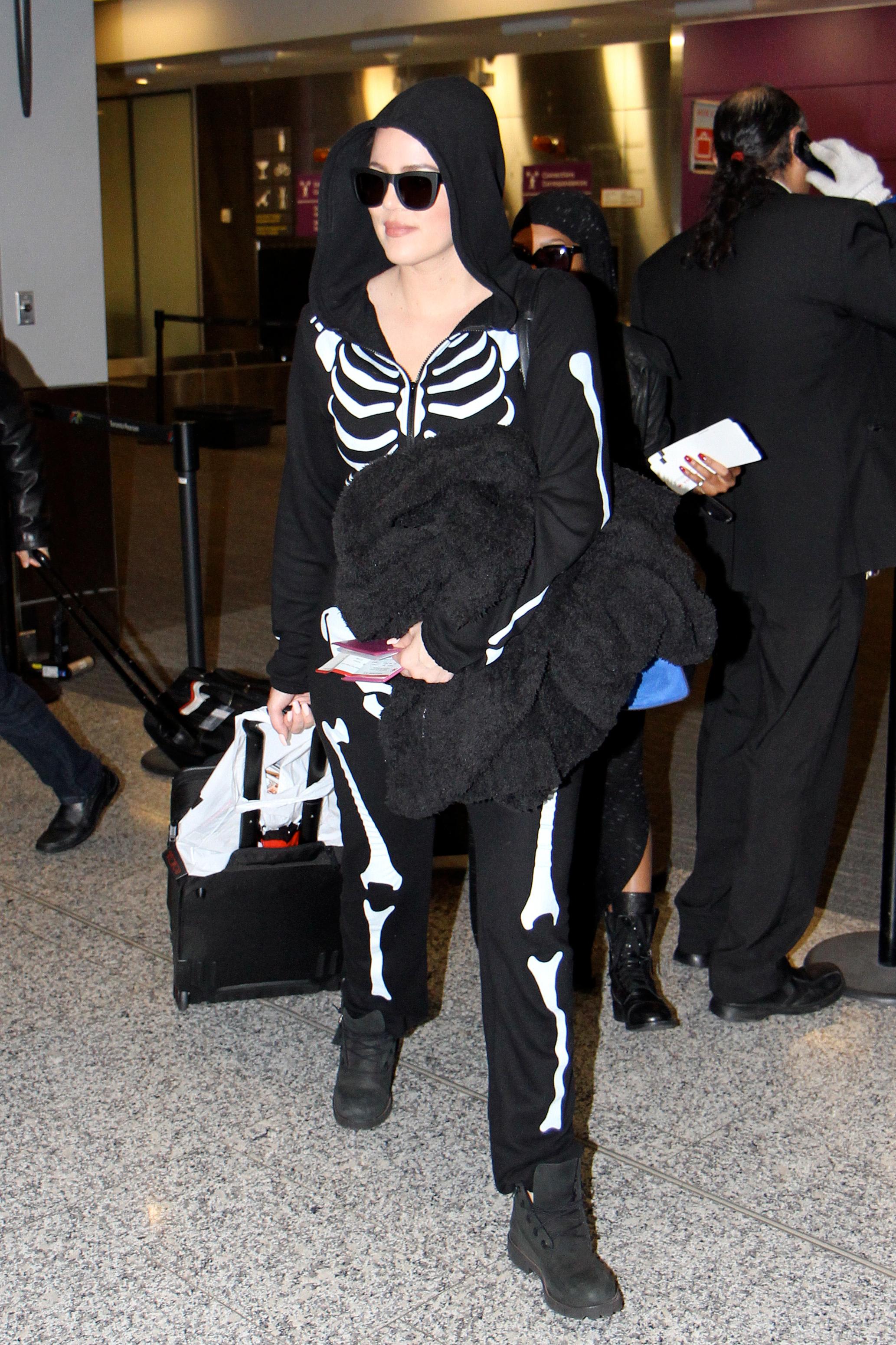 Khloe Kardashian wears a skeleton onesie on Halloween while arriving in Toronto