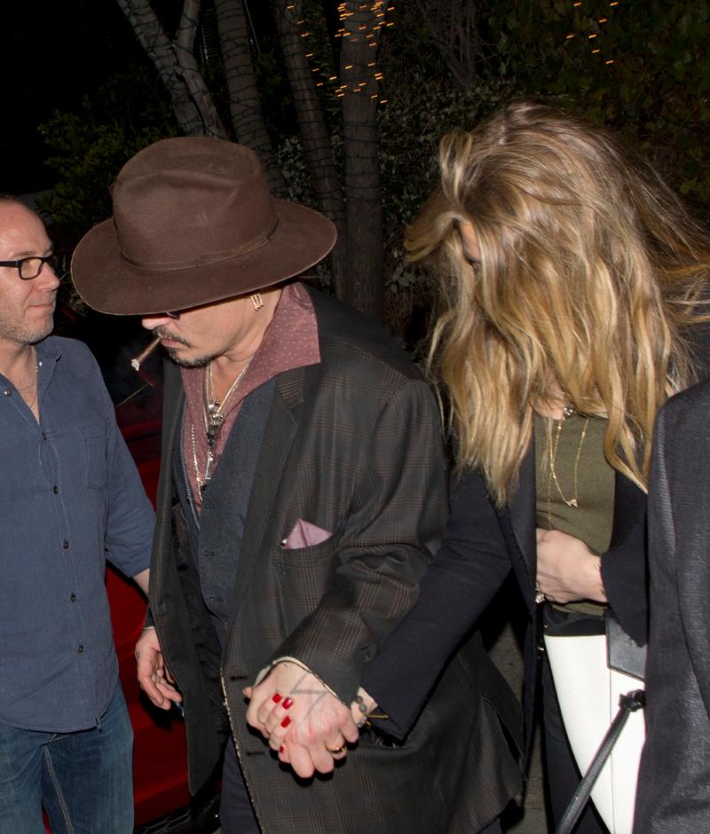 EXCLUSIVE: ***PREMIUM EXCLUSIVE RATES APPLY*** Amber Heard seen holding her stomach with husband Johnny Depp as they were leaving &#8216;AGO&#8217; Restaurant in West Hollywood, CA