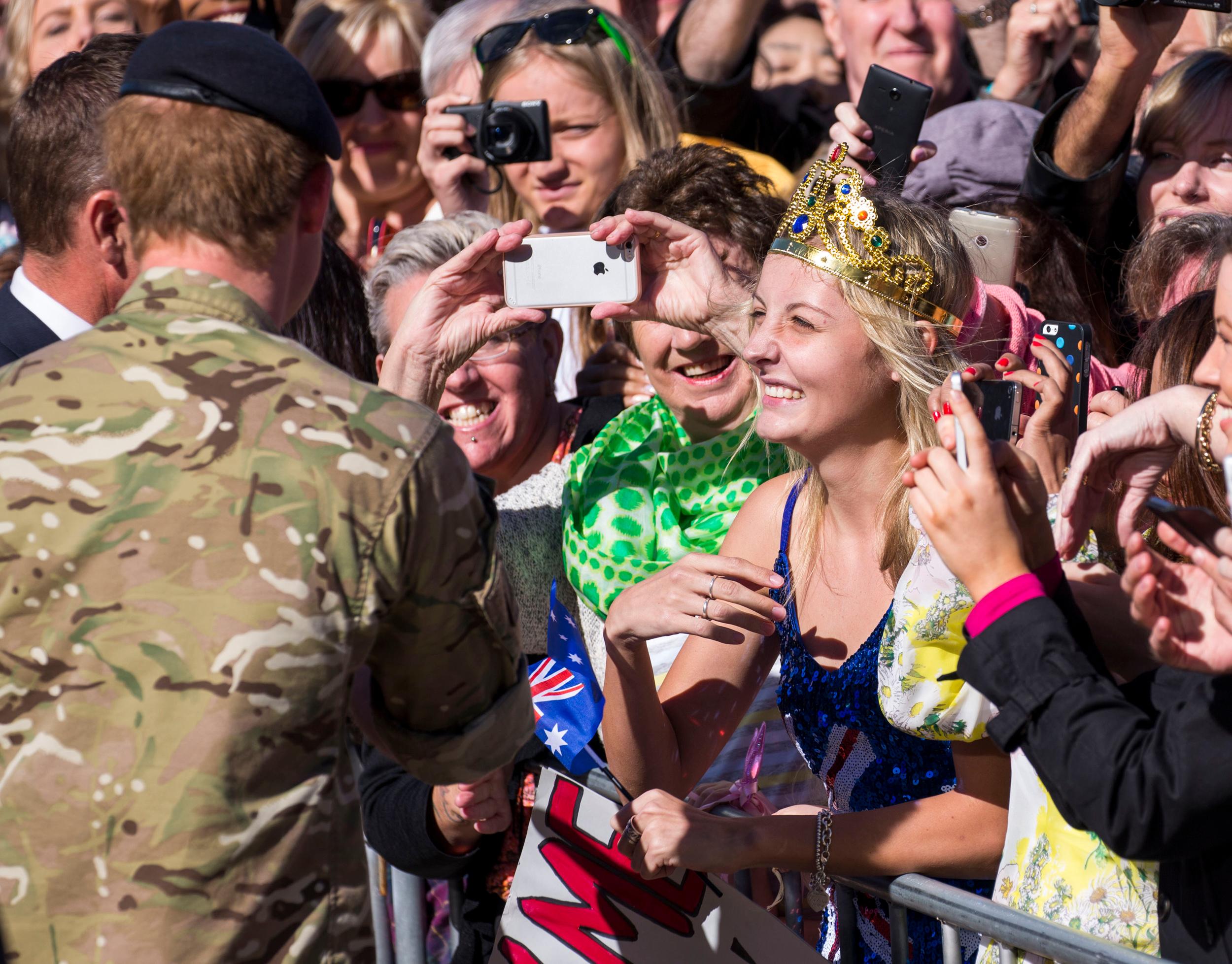 Prince Harry plants a kiss on an adoring fan! **USA ONLY**