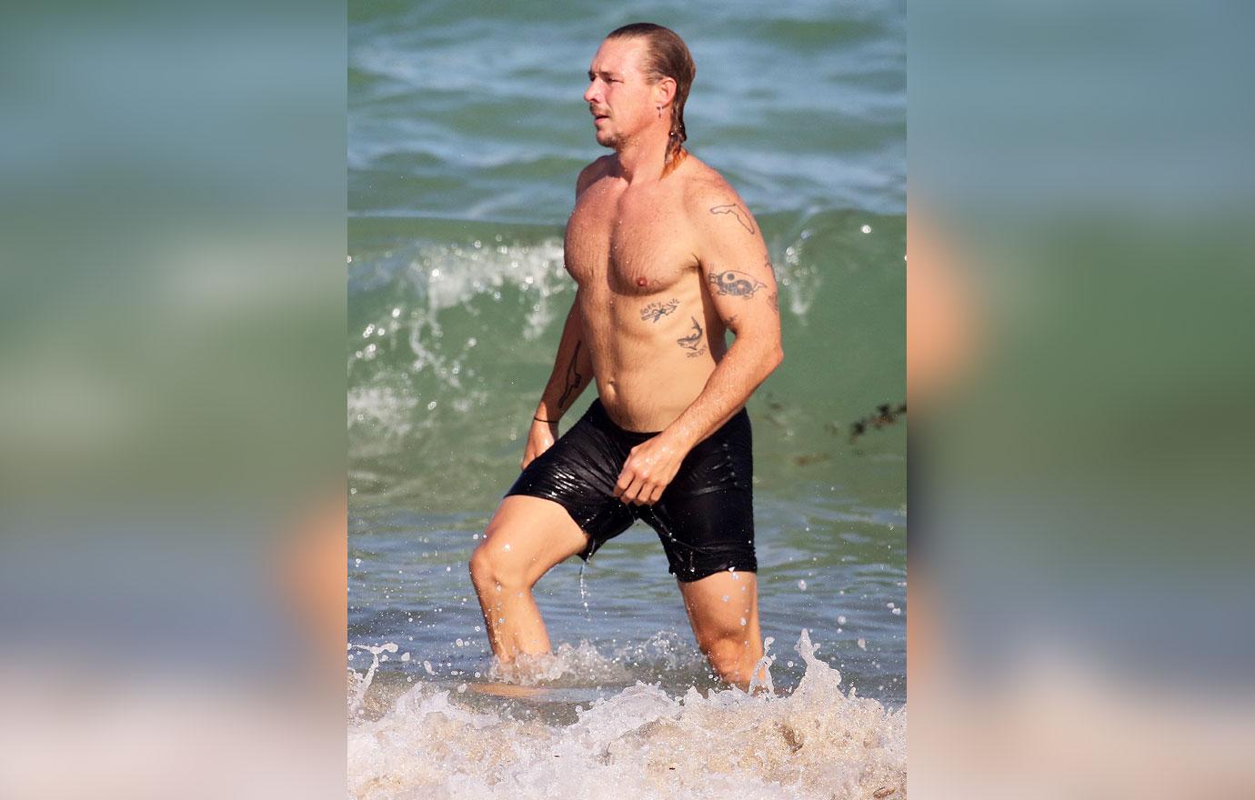 shirtless men on the beach diplo