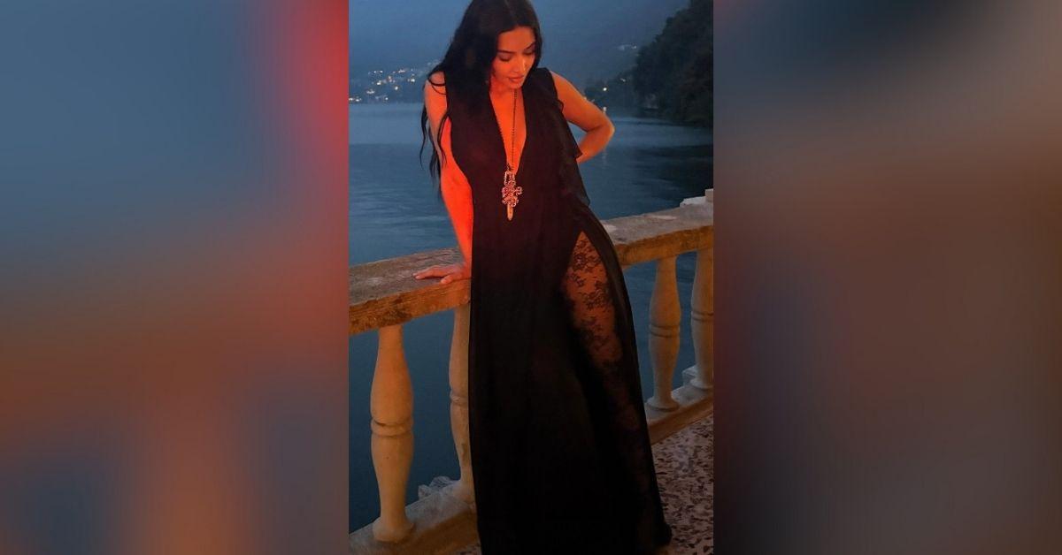 image of The reality star showed off her curves in a black low-cut dress with high slit.