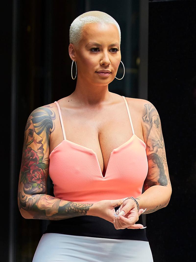 Amber Rose spotted wearing a body hugging pink striped dress while visiting an office building in the Midtown Manhattan neighborhood of NYC