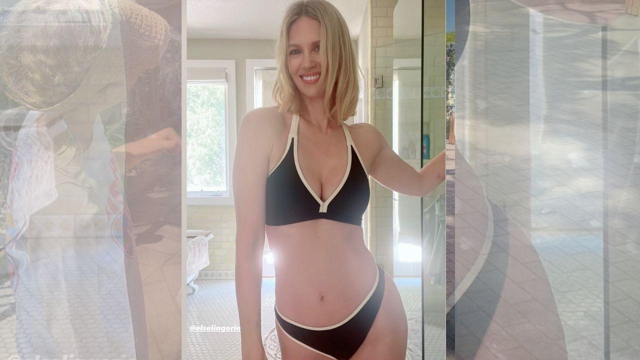 Image of January Jones flashed a huge smile as she modeled the black two-piece with contrasting white trim.