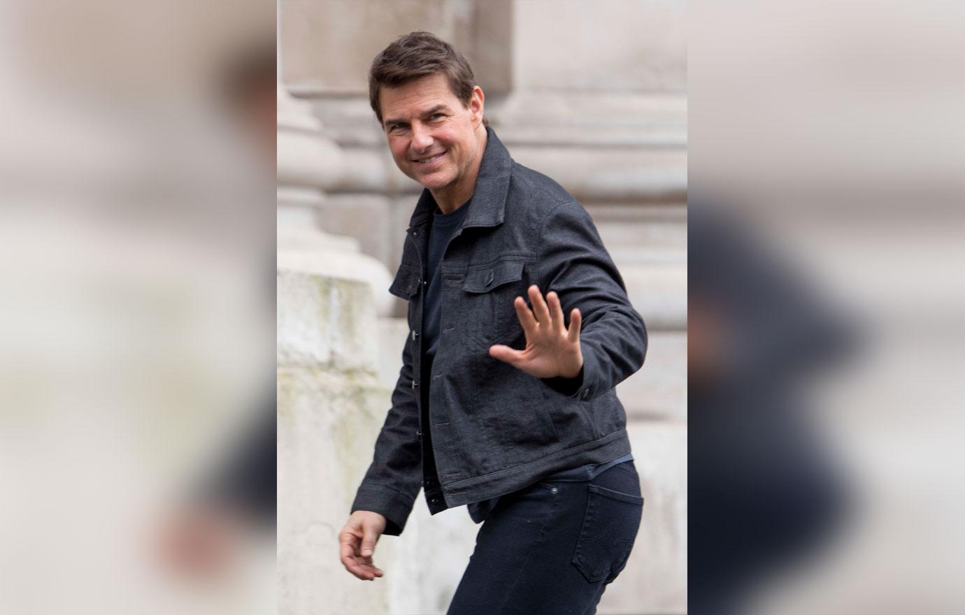 Tom Cruise waves to photographers as he walks onto the set of Mission Impossible 6 in Central London.