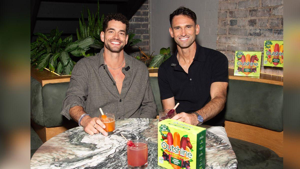image of Carl Radke and Jesse Solomon celebrate summer, enjoying refreshing mocktails crafted with Outshine Mini Fruit Pops at Soft Bar. 