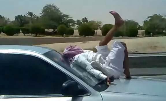 //saudi_man_texting_car_hood_freeway_stack_