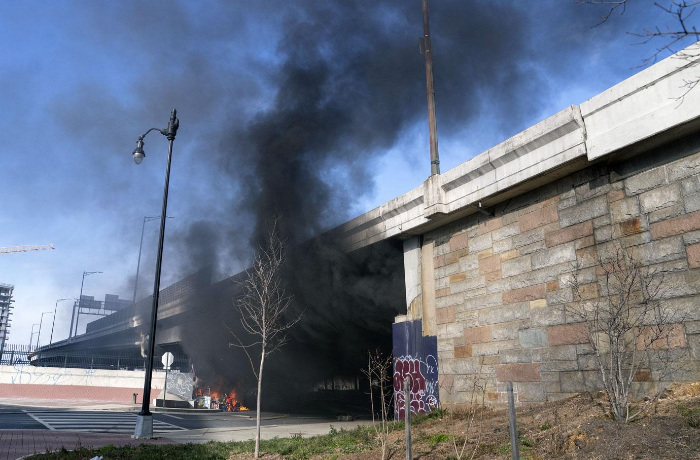 Thick smoke is seen as a fire breaks out at a homeless encampment near the U.S. Capitol in Washington, DC on Monday, January 18, 2021. The fire caused a security lockdown during the inauguration rehearsal. 