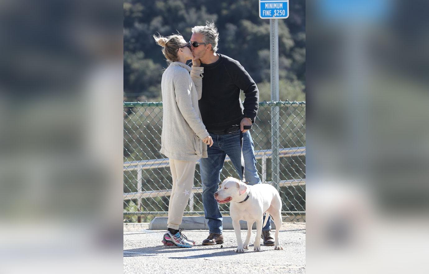 *EXCLUSIVE* Joanna Krupa packs on the PDA on an outing to the dog park with a mystery man