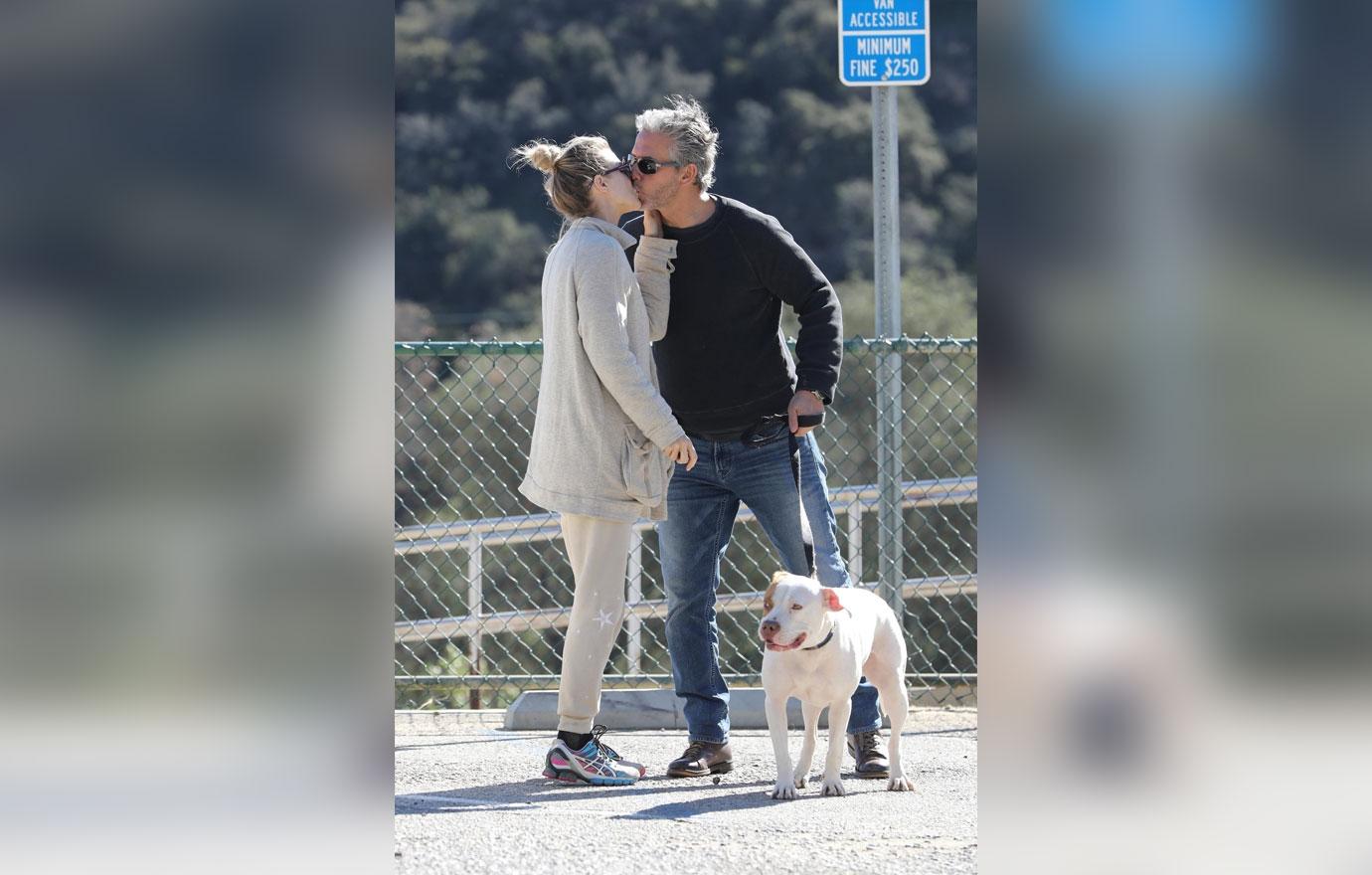 *EXCLUSIVE* Joanna Krupa packs on the PDA on an outing to the dog park with a mystery man