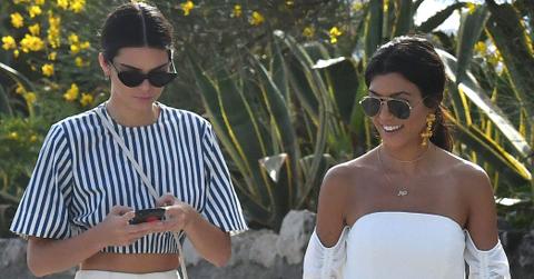 Kendall Jenner and Kourtney Kardashian walking on the beach during the 70th Cannes Festival