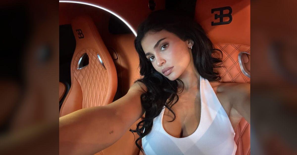 Image of Kylie Jenner wore her black hair in loose curls.