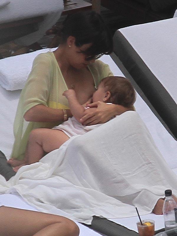 Kourtney Kardashian breastfeeding baby daughter Penelope Disick poolside in Miami Beach