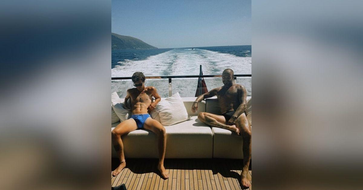image of David and Cruz Beckham posed in Speedos while on a boat.