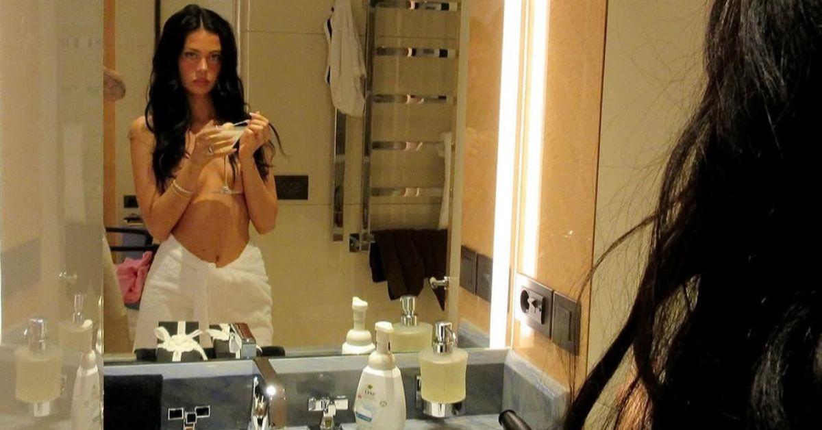 image of Nicola Peltz ditched her top in a revealing mirror photo.