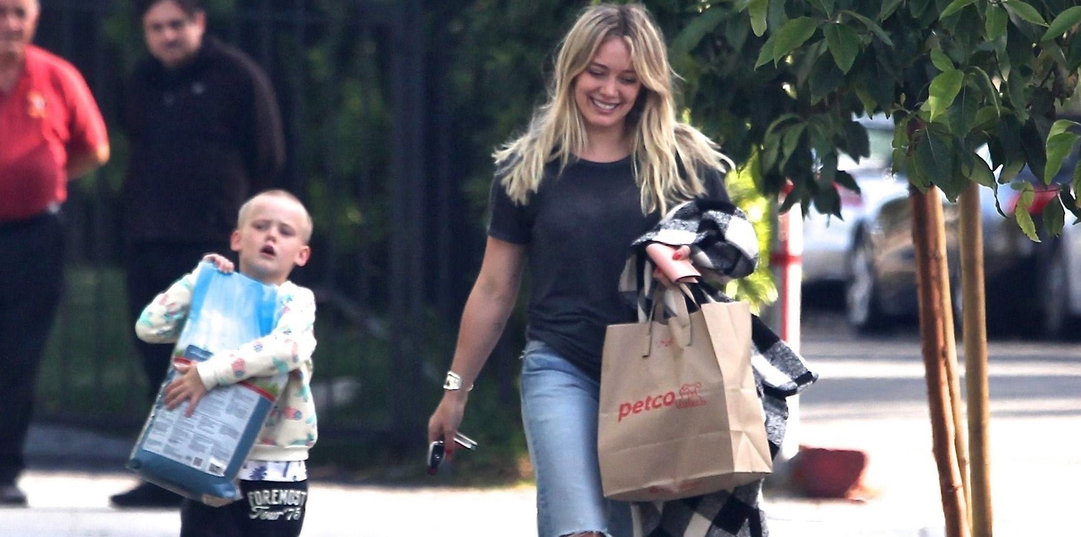 *EXCLUSIVE* Hilary Duff gets some help from Luca carrying the dog food